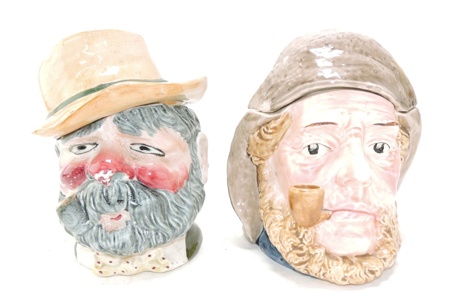 Majolica lot of 2 head tobacco jars,: 8", one a hobo and the other a sailor (hole in lid)