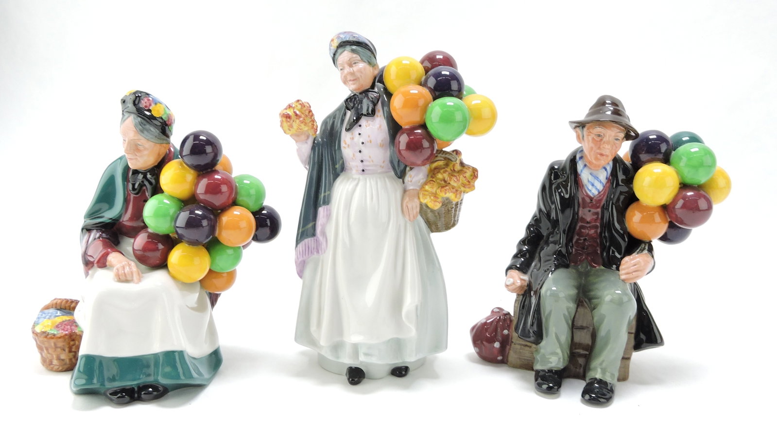 Royal Doulton lot of 3 figures:: The Old Balloon Seller, Biddy Pennyfarthing, The Ballon Man, 7 1/2" to 8 1/2"