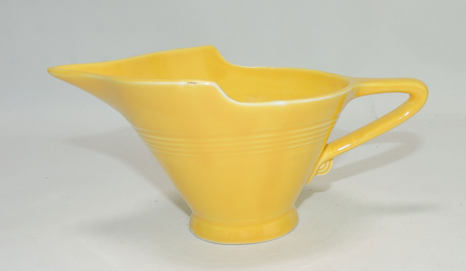 Harlequin high lip creamer, yellow,: small nick to foot rim