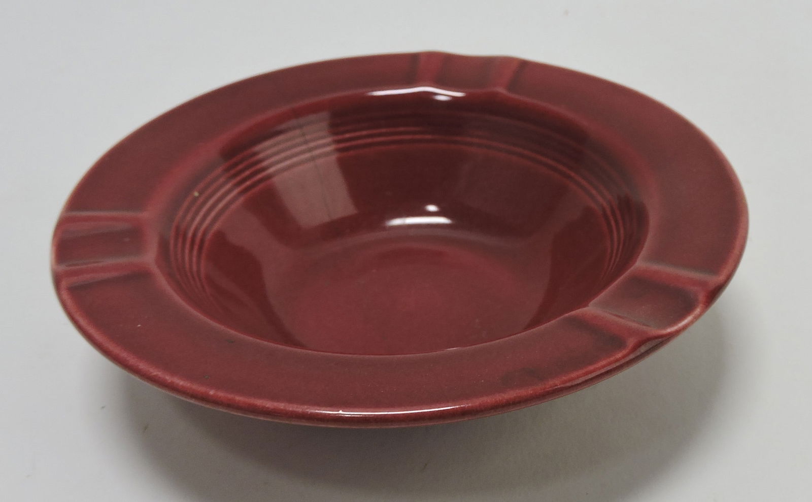 Harlequin ashtray, maroon, marked HLC (1 of 1)