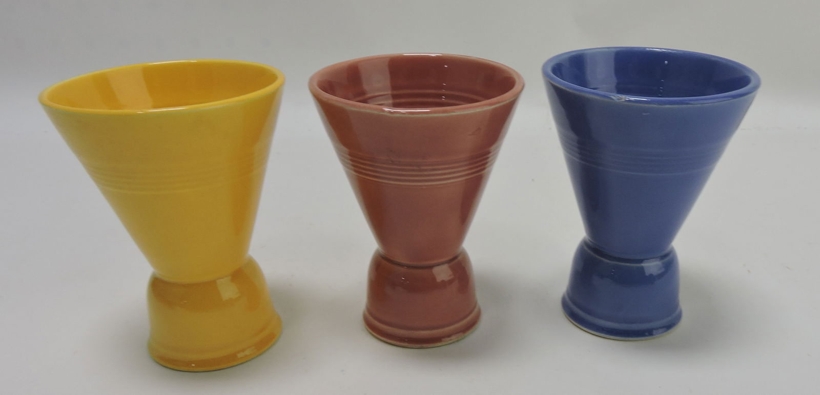 Harlequin double egg cup group, 3 mixed,: 2 with minor nicks