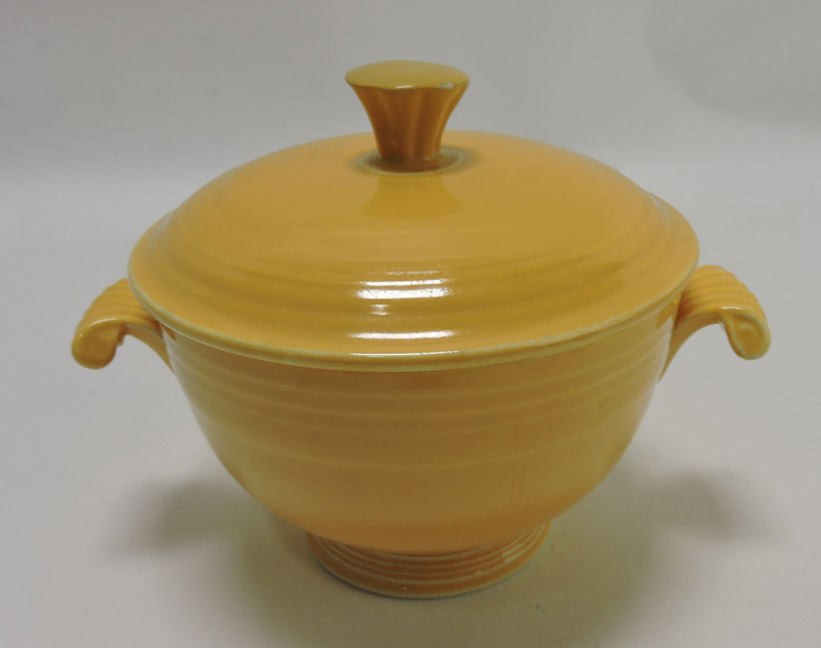 Fiesta covered onion soup, yellow,: finial repair, rim nick, and repair to base