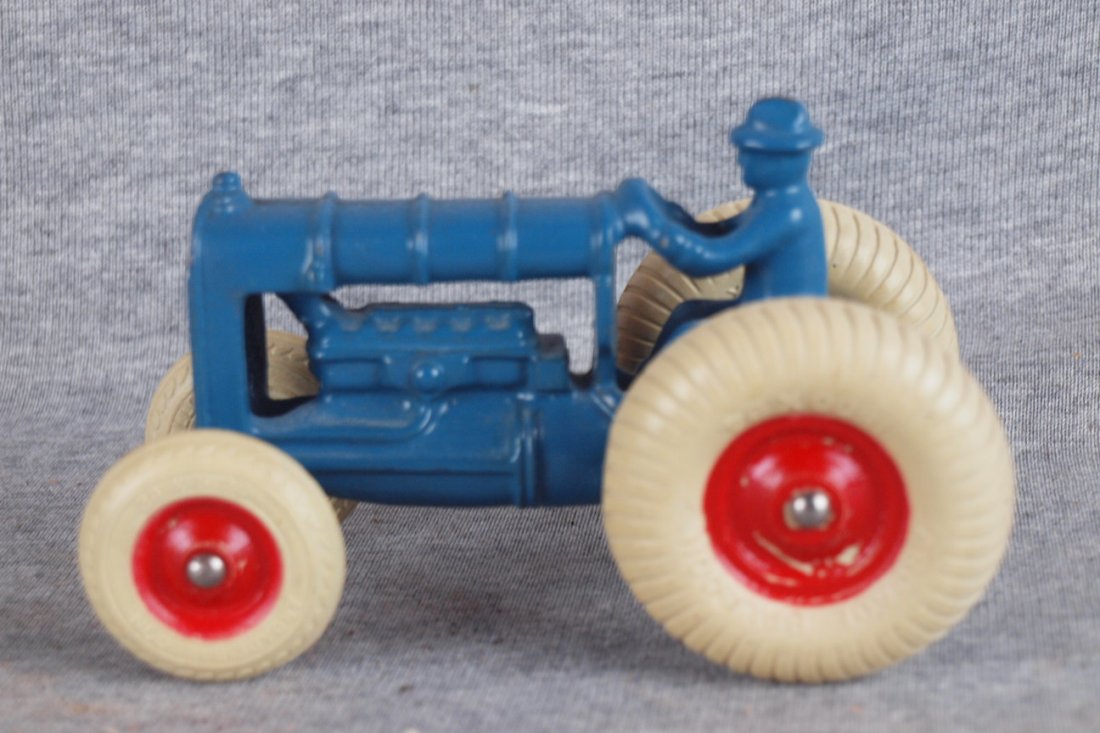 Arcade cast iron Fordson tractor and rider with ball: Arcade cast iron Fordson tractor and rider with balloon tires in excellent original condition, 5 1/2"