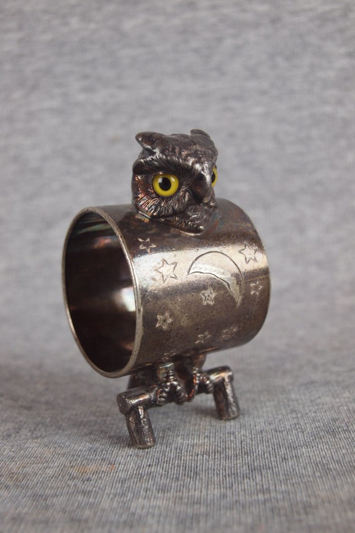 Silver figural napkin ring of an owl with glass eyes,