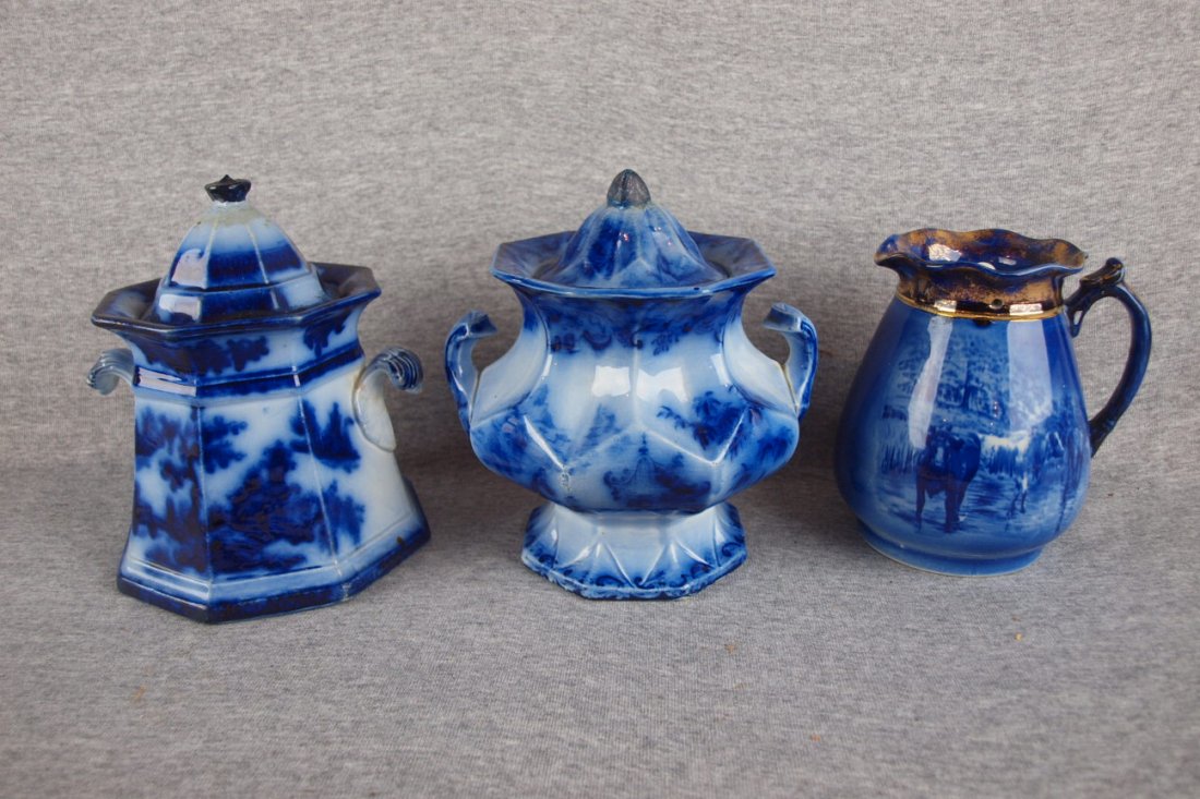 Flow blue lot of 3 pieces - 2 large covered sugars (r: Flow blue lot of 3 pieces - 2 large covered sugars (repairs to lids) and syrup pitcher