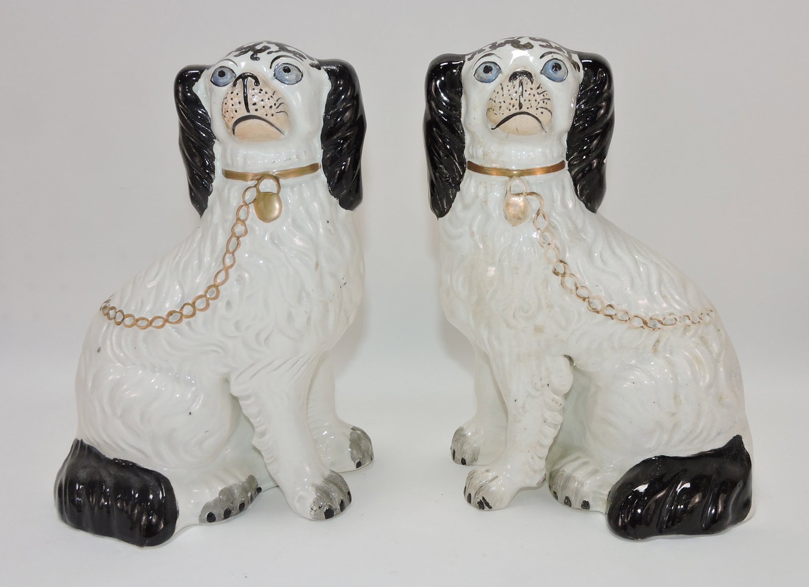 Staffordshire pair of free leg black and: white spaniels, 9 1/2"