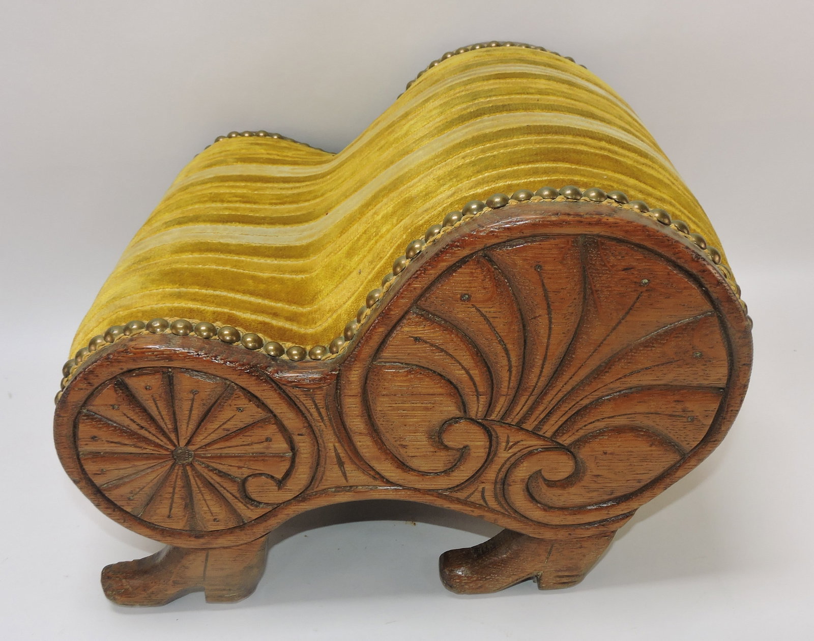 Oak footstool with carved boots for feet: .