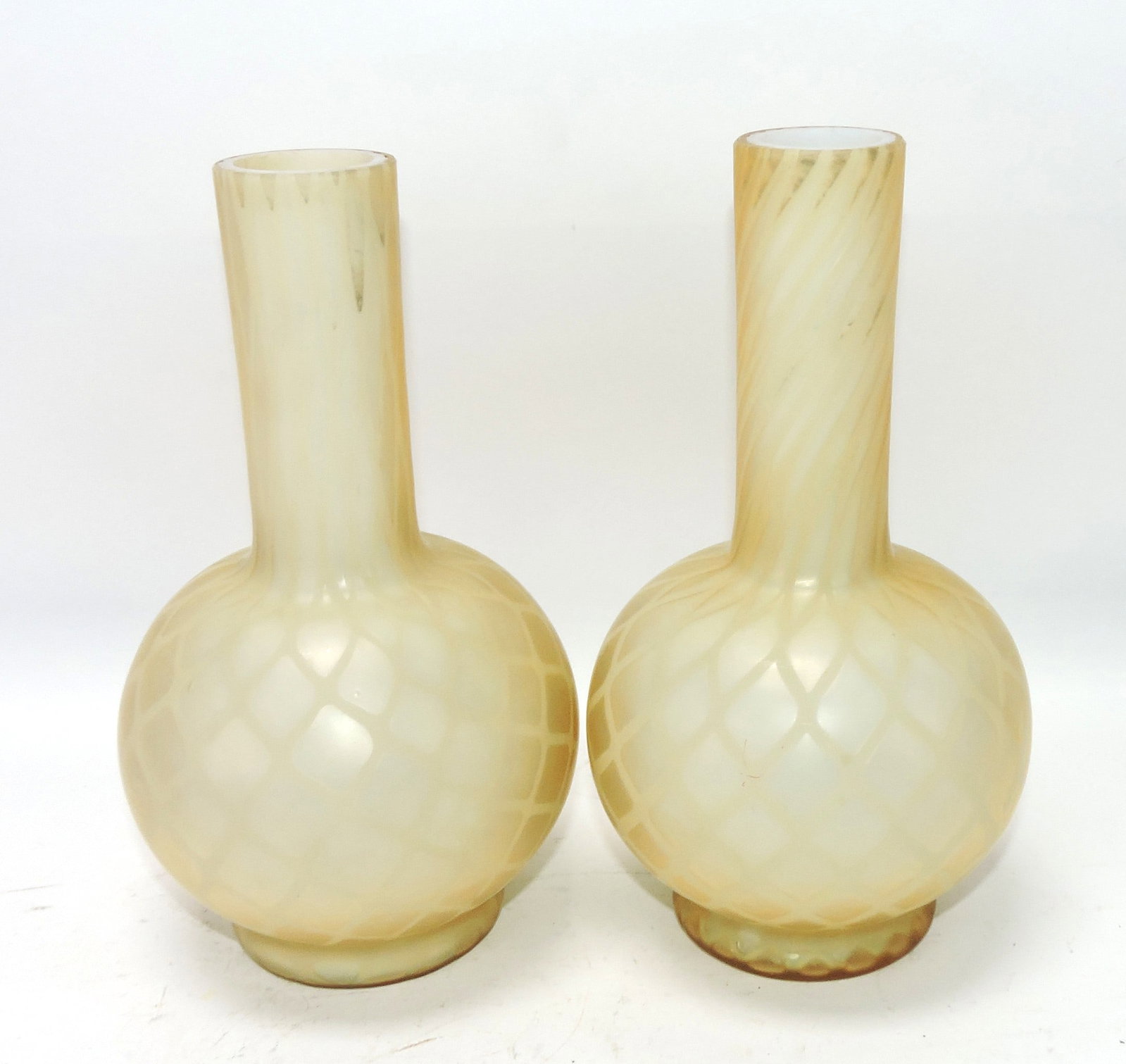 Amber cased glass pair of bottle vases: .