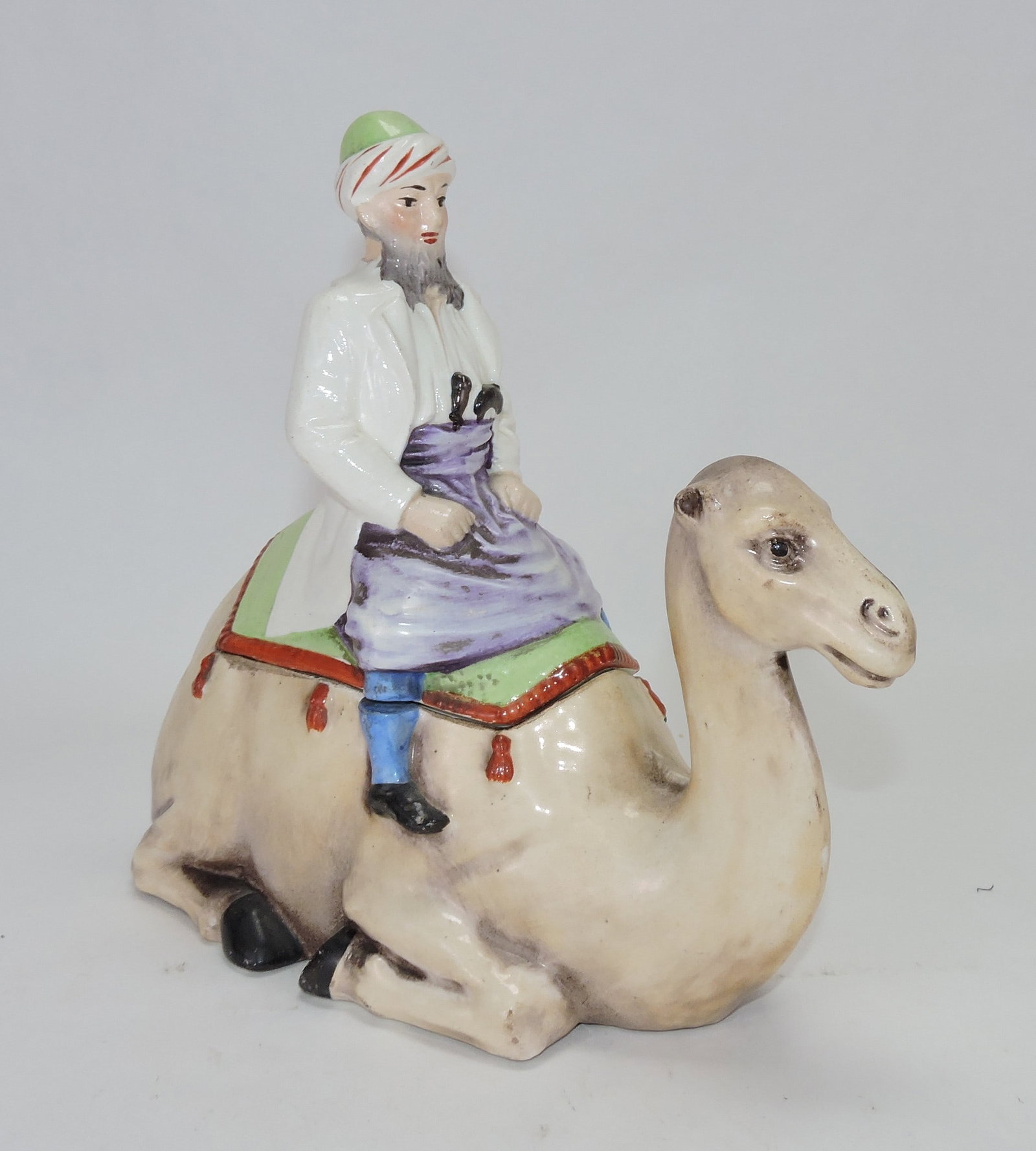 Porcelain man riding camel figural (1 of 1)