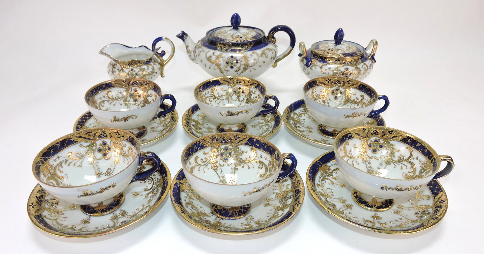 Nippon cobalt, gold, and jeweled tea set: with teapot, cream, sugar, and 6 cups/saucers. The Dwight & Helen Wilmoth Collection
