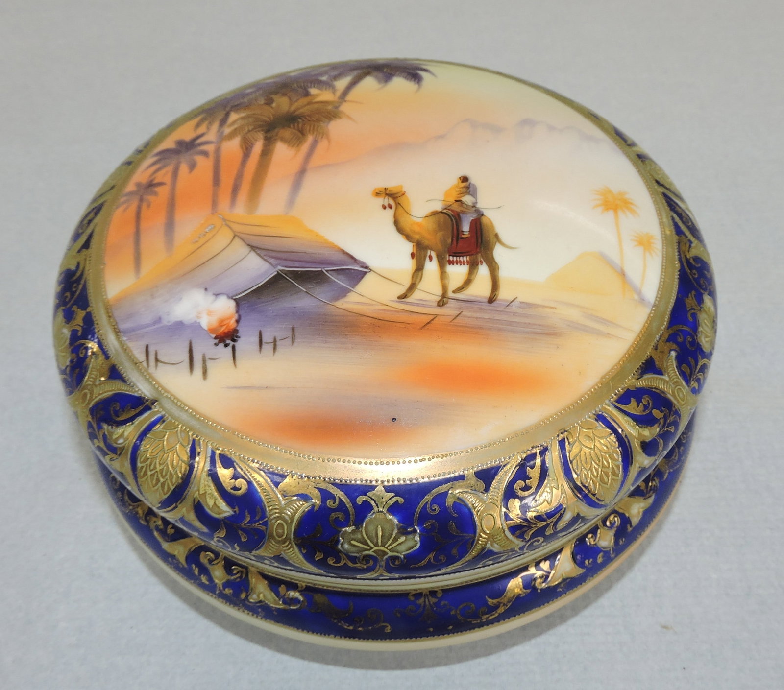 Noritake 7" round covered jar with: cobalt, heavy gold, and Egyptian scene. The Dwight & Helen Wilmoth Collection