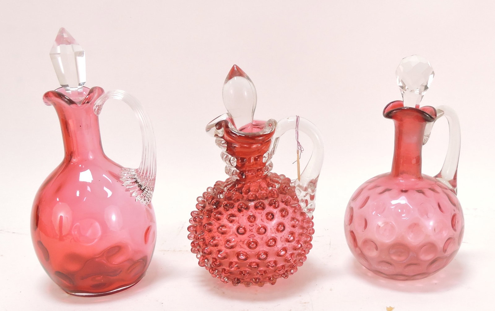 Cranberry glass lot of 3 cruets: .
