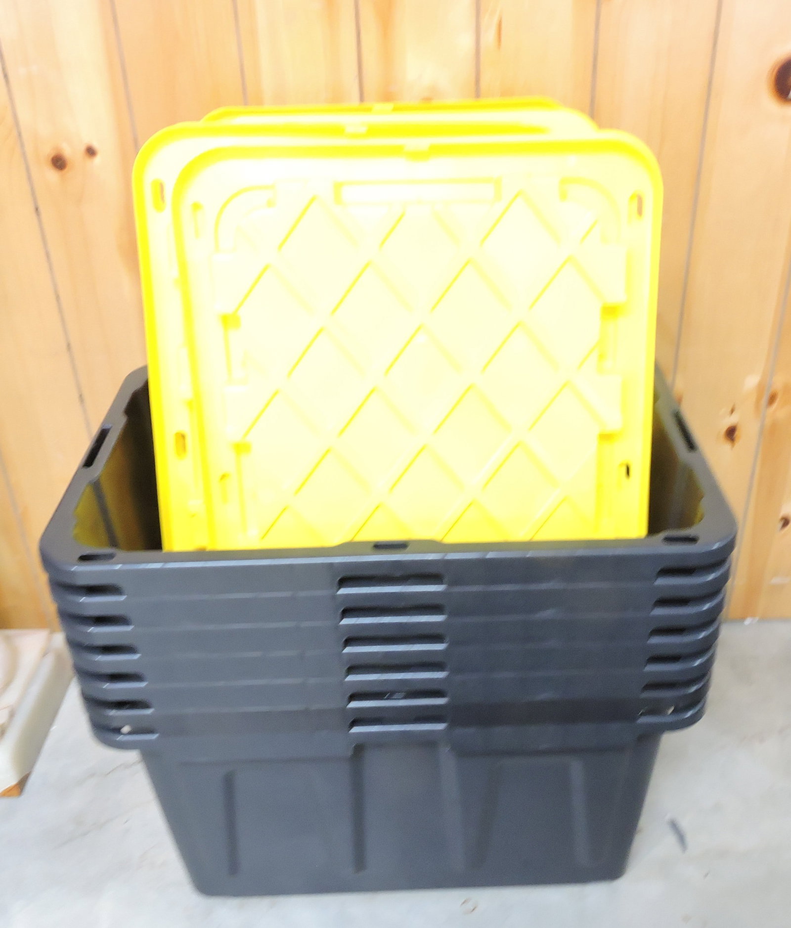 Lot of 7 black/yellow plastic totes with: lids