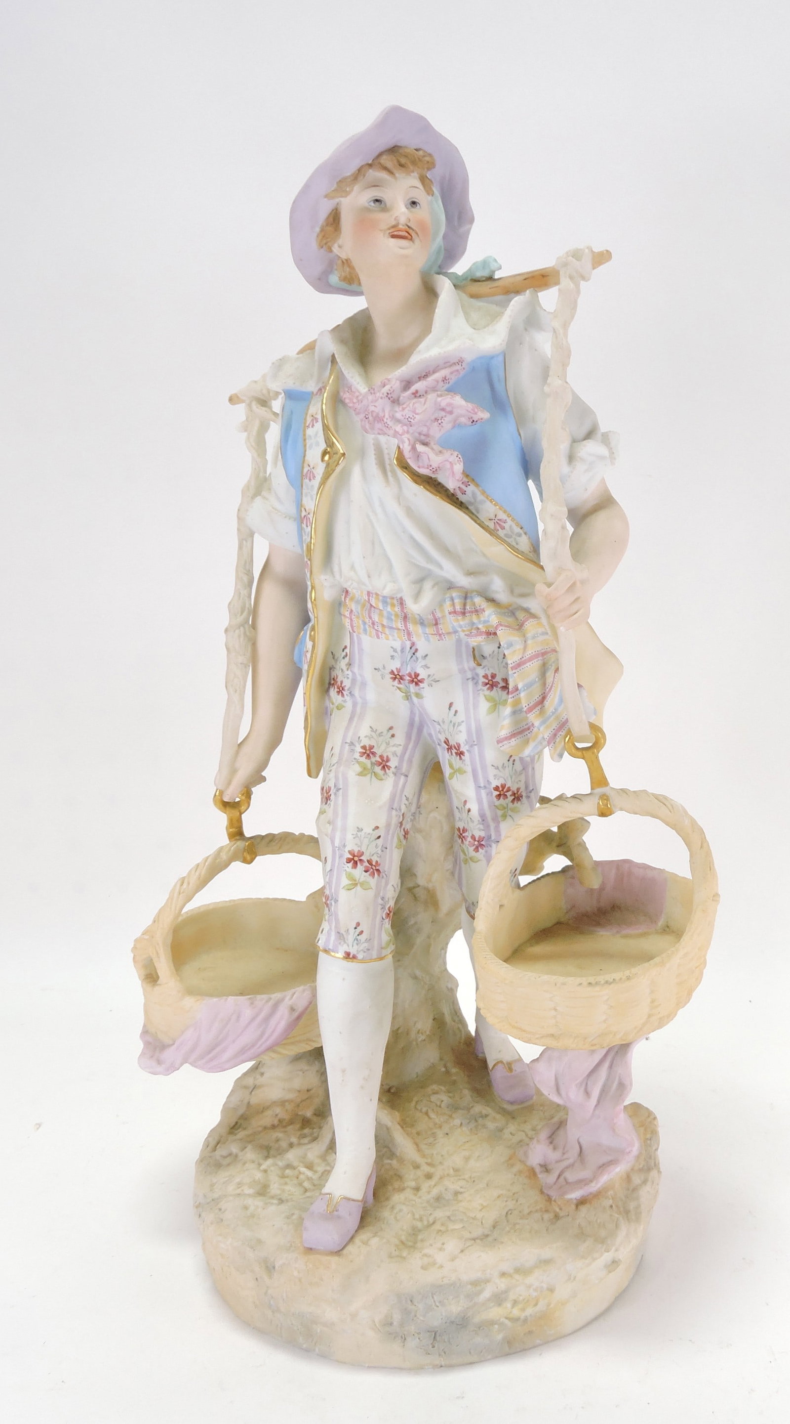 Bisque figure of a man carrying (1 of 3)