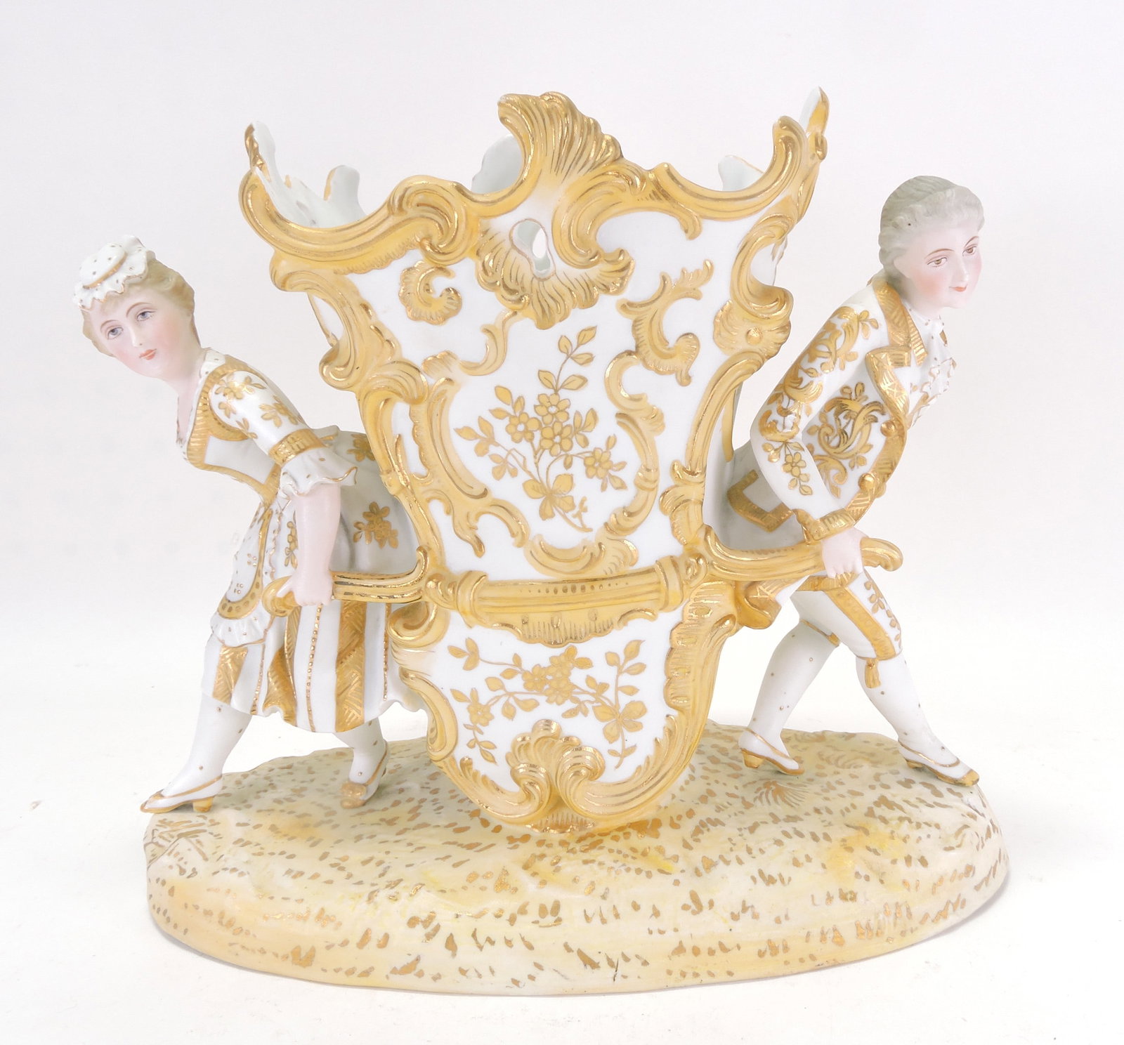 Bisque table center with man and: woman carrying a vase, lots of gold gilting, 10"