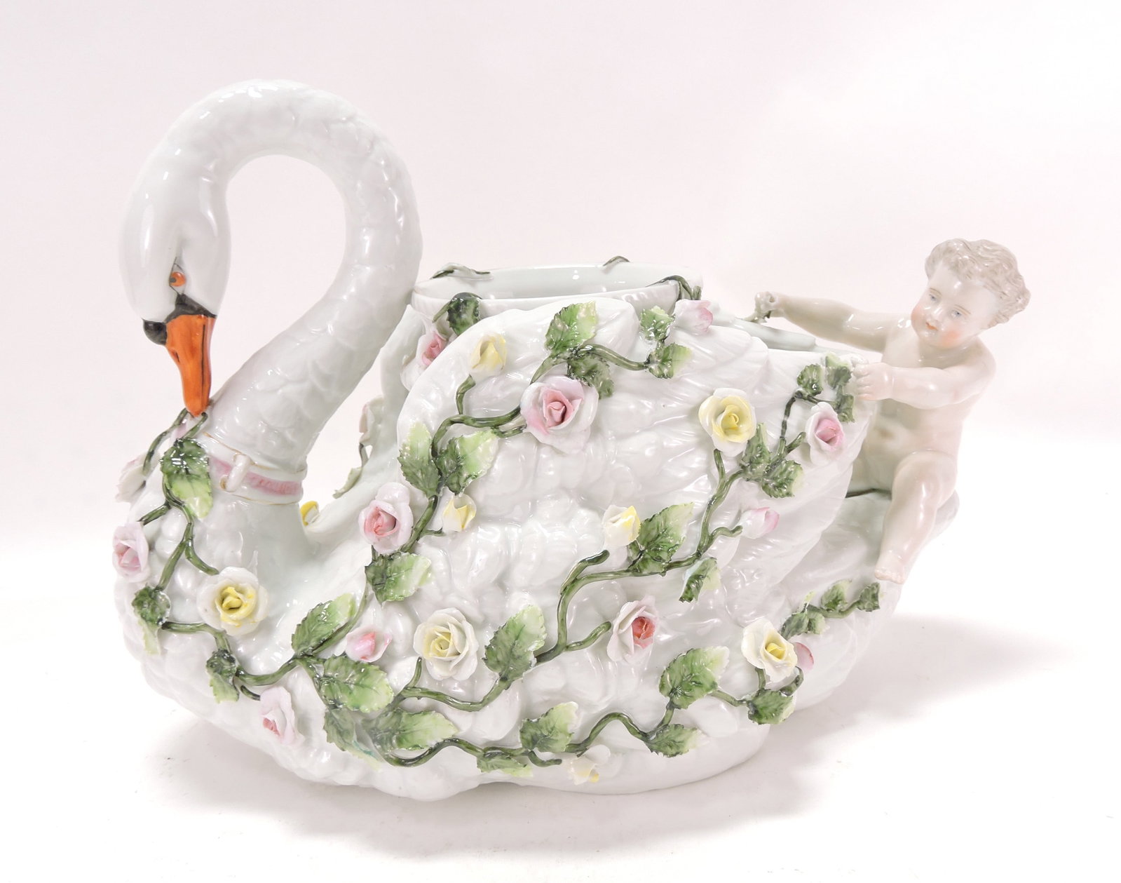 Meissen swan table center with flower: blossoms, leaves, and cherub, minor losses to blossoms and leaves, 8"h, 11"w