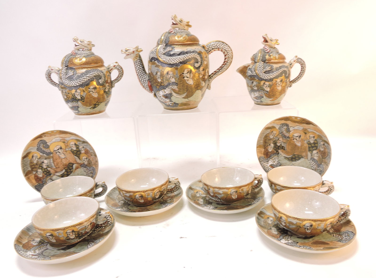 Satsuma Oriental porcelain tea service: with dragon finial teapot, sugar, creamer, and 6 cups & saucers