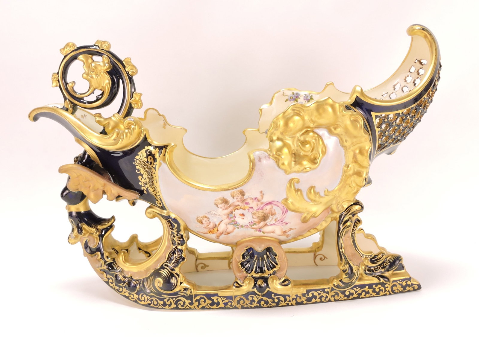 Fischer Budapest Hungary sleigh with: cherub and floral decor, hairline to one runner, 11 1/2"h. 16"l