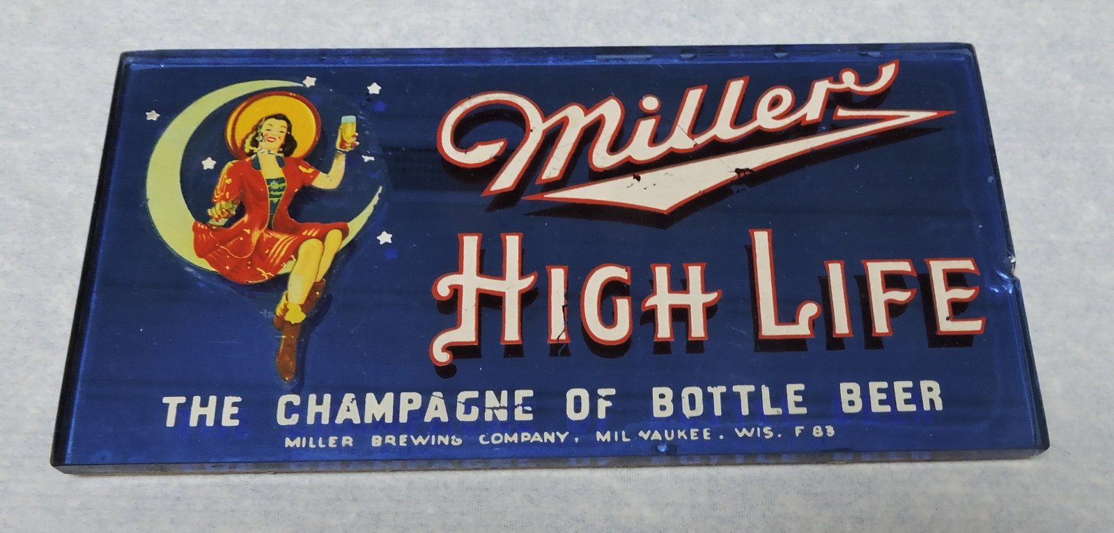 Miller High Life blue glass advertising: sign, 4"x8", chip to side
