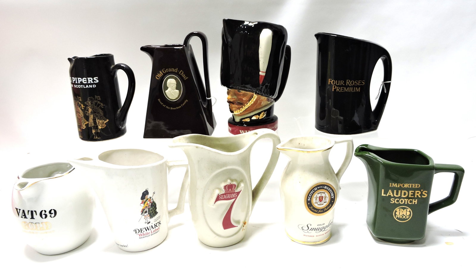 Lot of 9 ceramic advertising pitchers: .