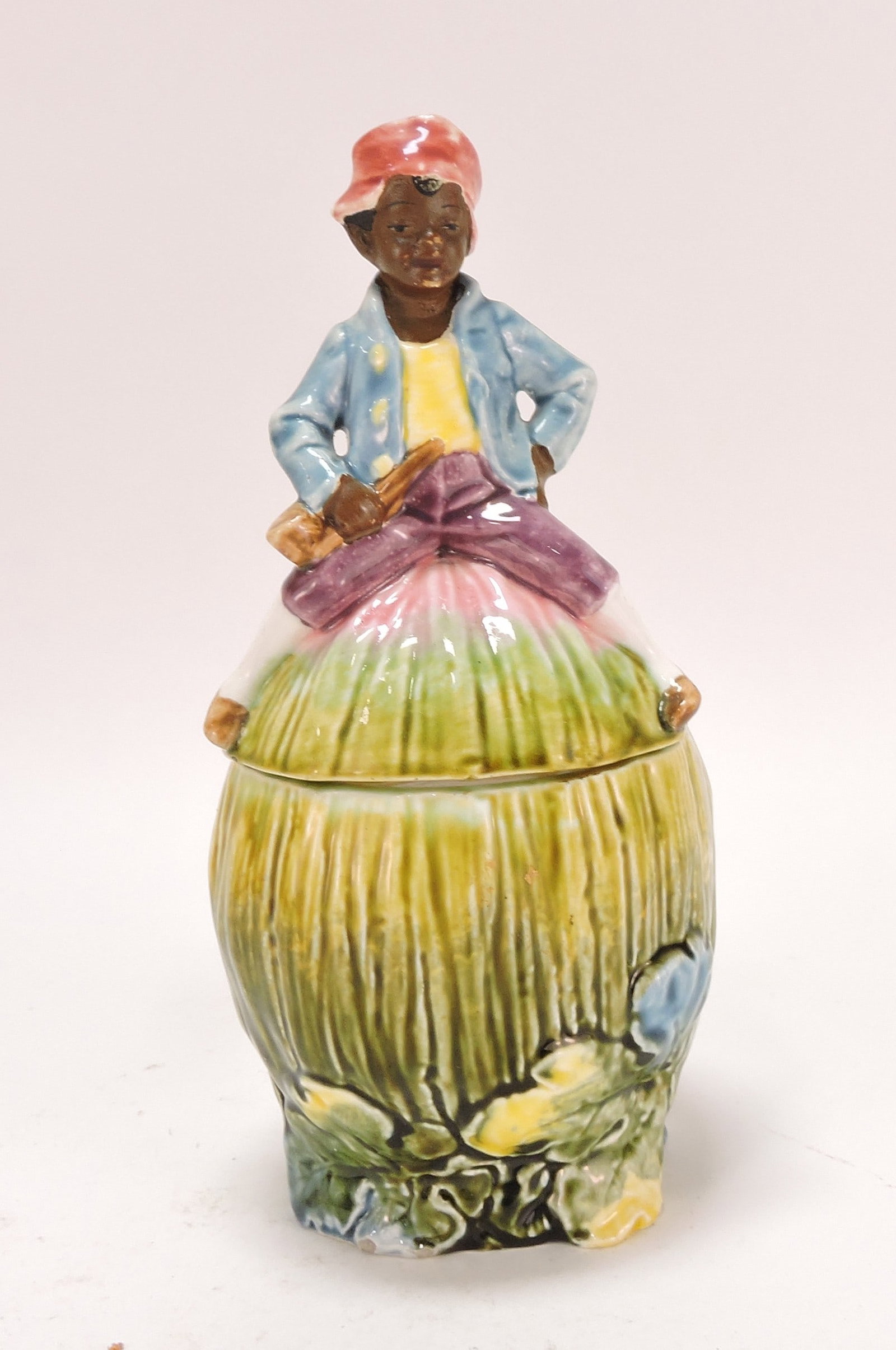 Black Americana majolica humidor: of man atop melon, 9"