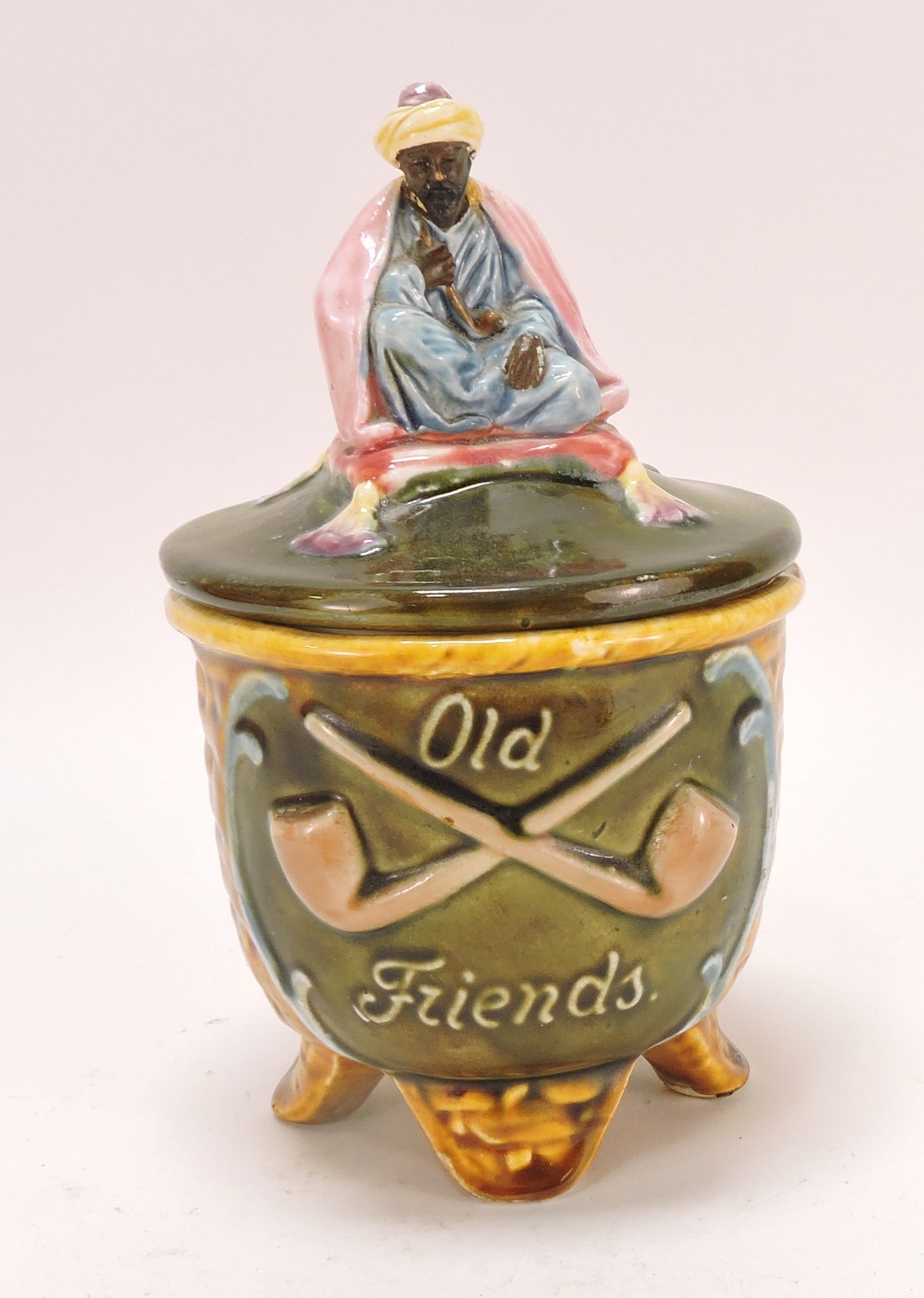 Black Americana majolica humidor: of man on pillow atop a basket, 'Old Friends', 8"