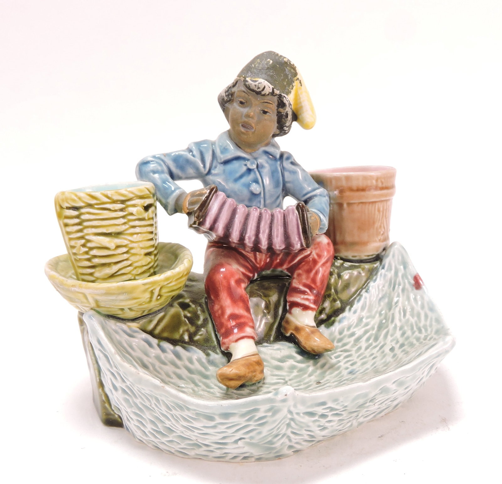 Black Americana majolica figural: match striker of man with accordion, 4 3/4"