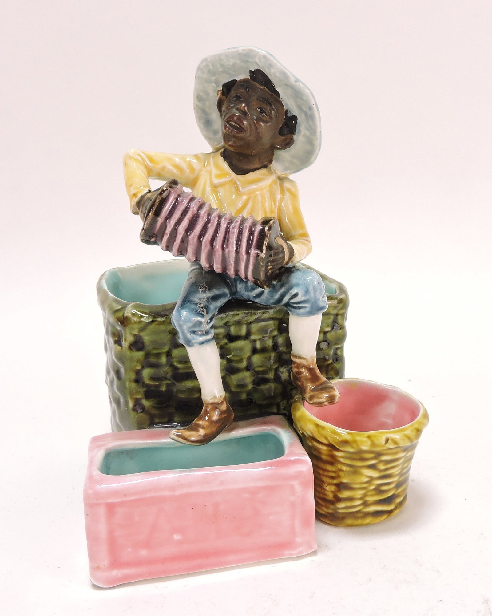 Black Americana majolica figural: match striker of man with accordion, 6 1/2"