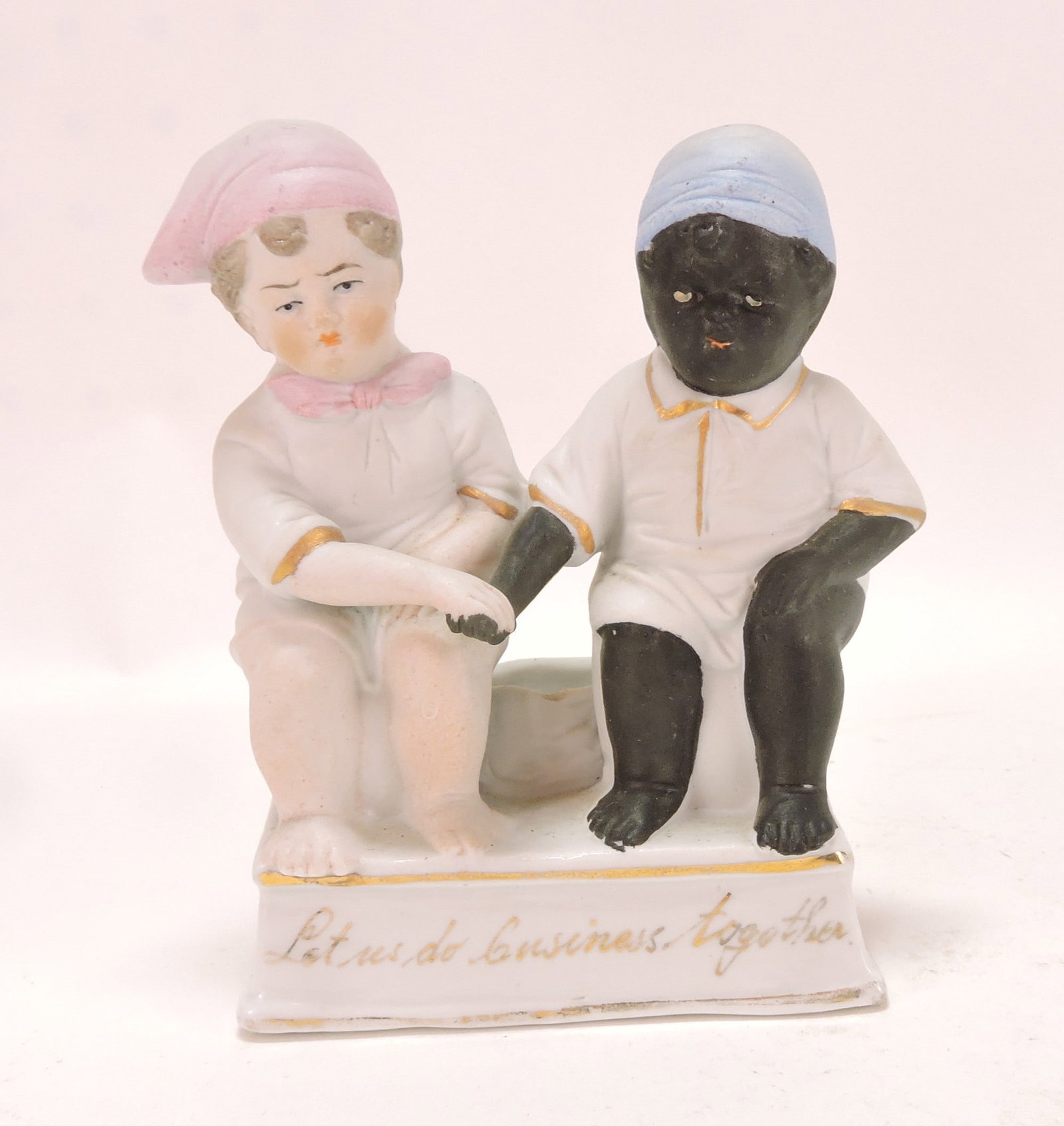 Black Americana German bisque: figural match holder of two children shaking hands, 'Let Us Do Business Together', 5"