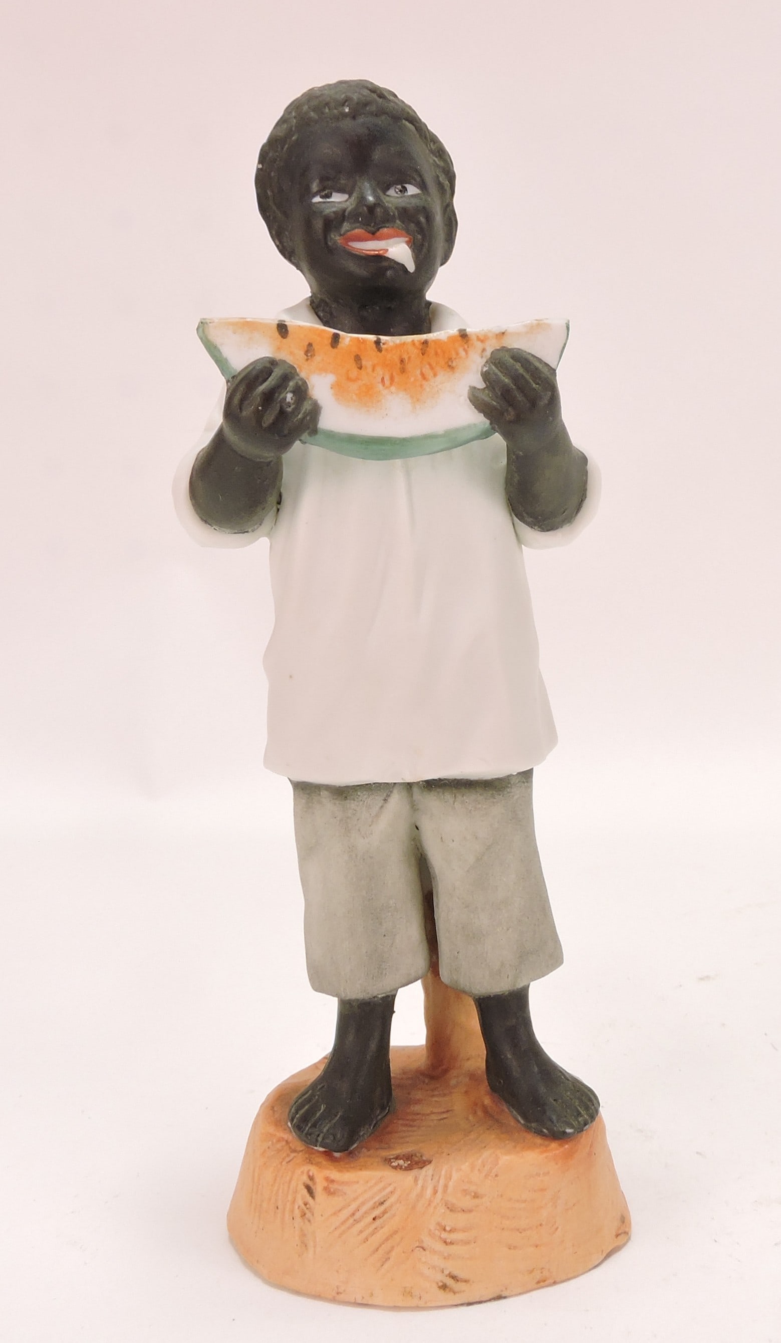 Black Americana bisque figure: of boy with watermelon, 6 3/4"