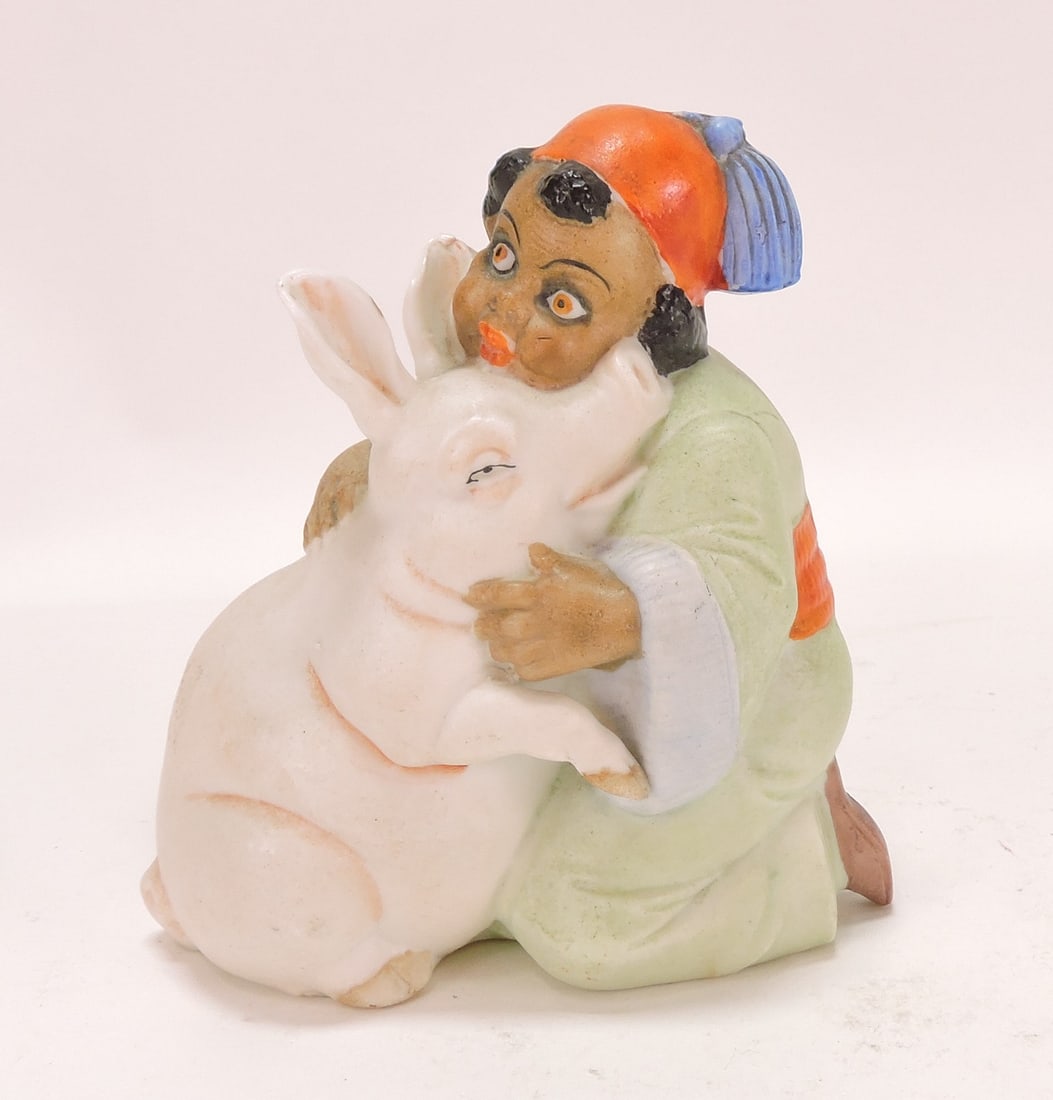 Black Americana bisque figural: match holder of boy with pig, 4"
