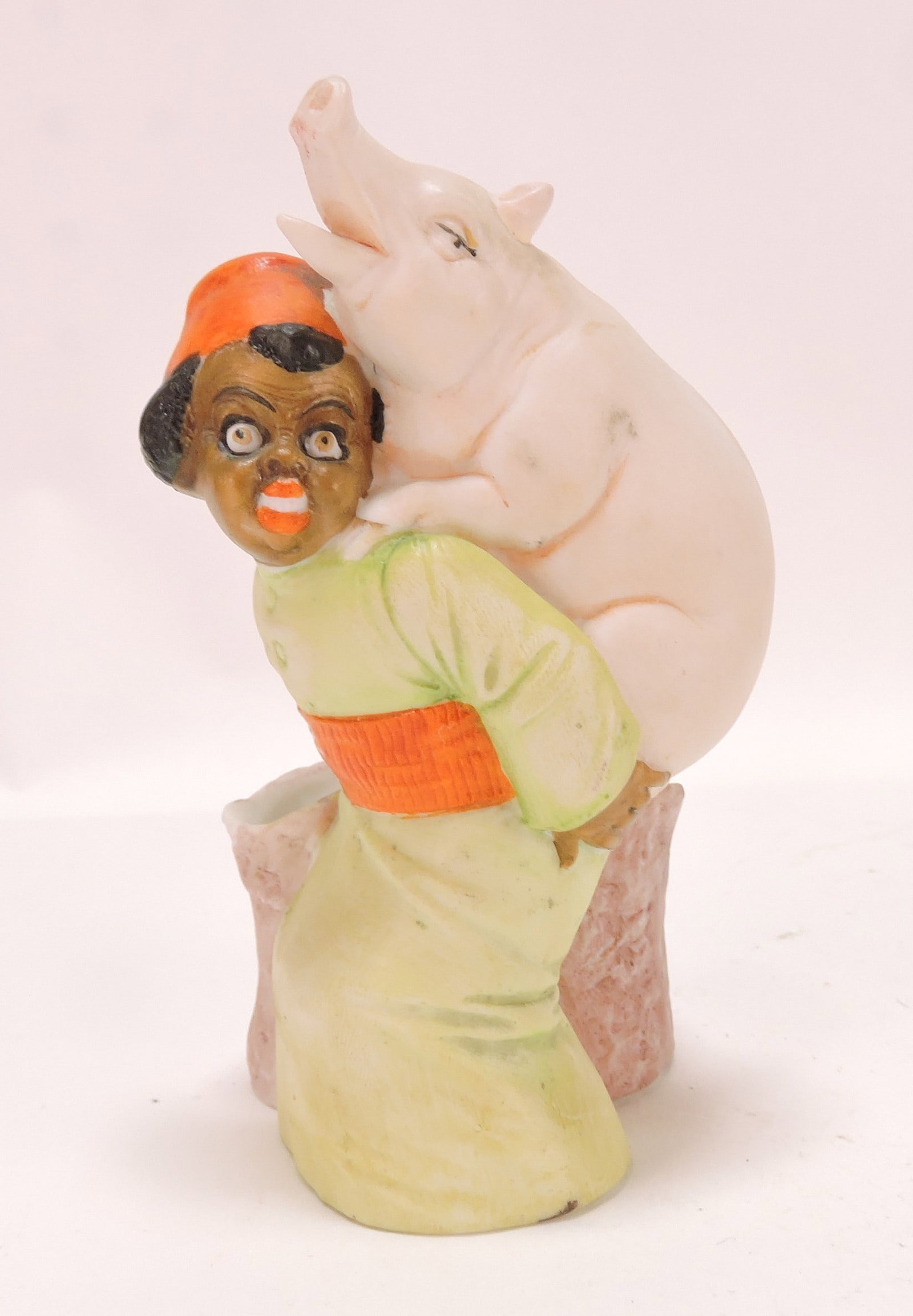 Black Americana bisque figural: match holder of boy with pig, 5"