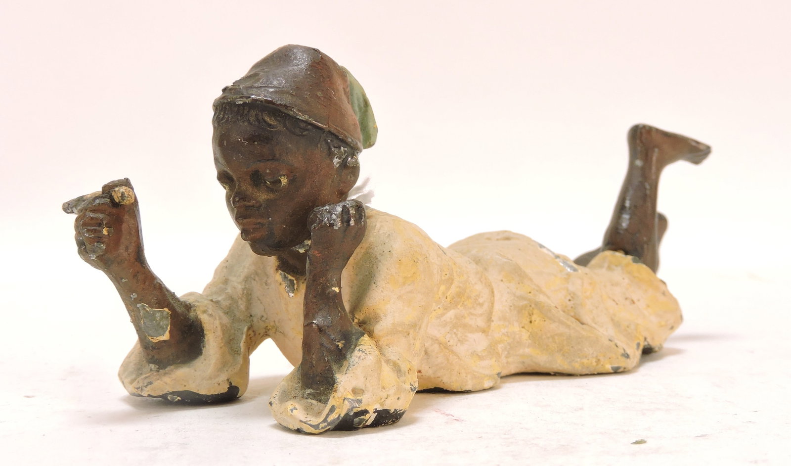 Black Americana spelter nodder of: recumbent man with cigar, 5 1/2"