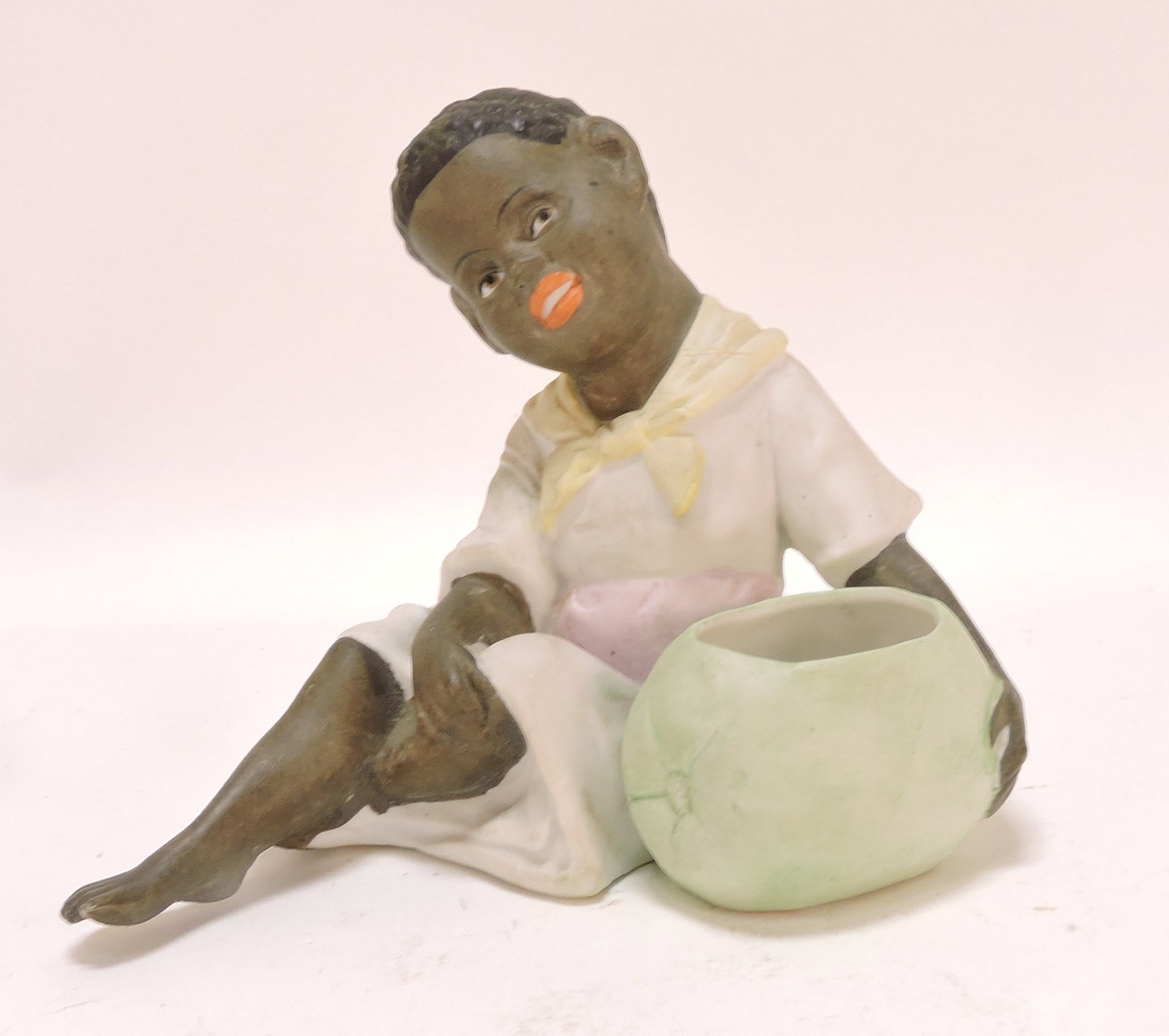 Black Americana bisque figure of boy: with melon, 4"