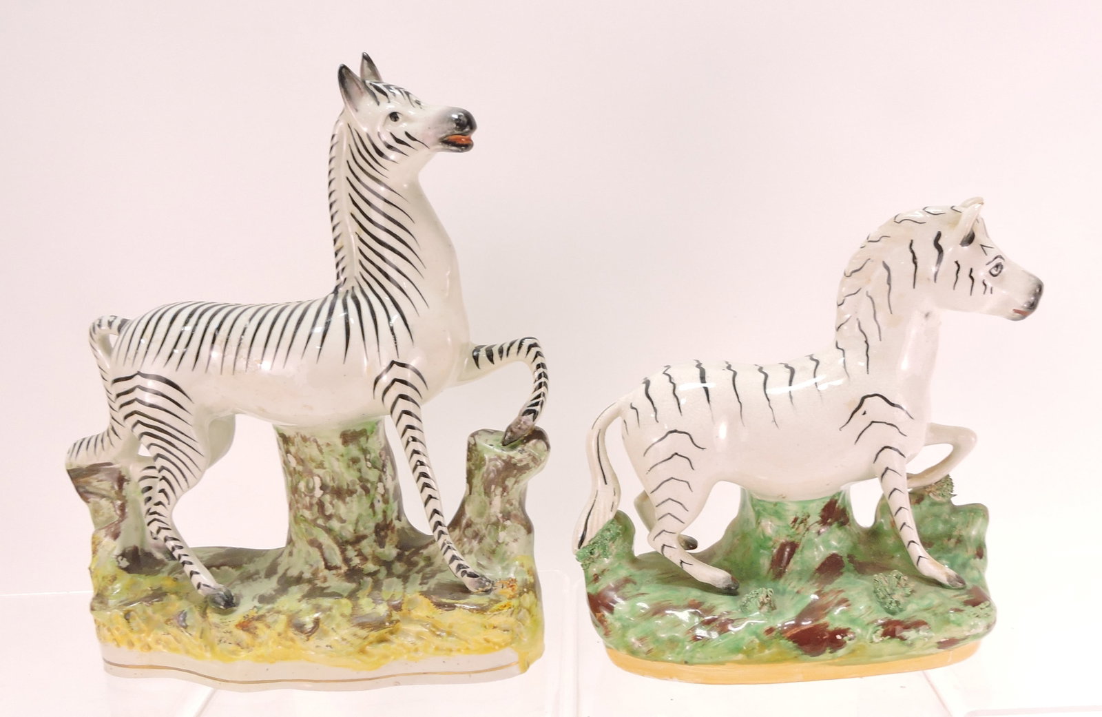 Staffordshire lot of 2 zebra figures,: 8" to 10"