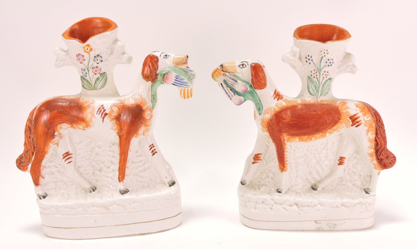 Staffordshire pair of dog spill vases,: 9"