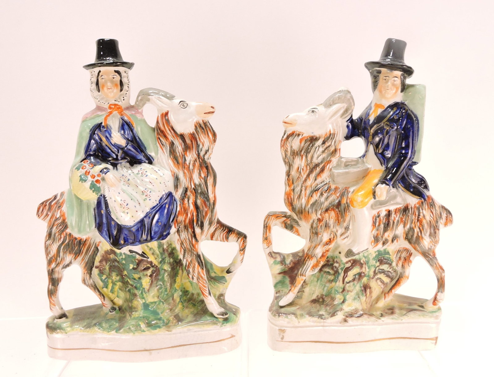 Staffordshire pair of goats with riders,: 11"