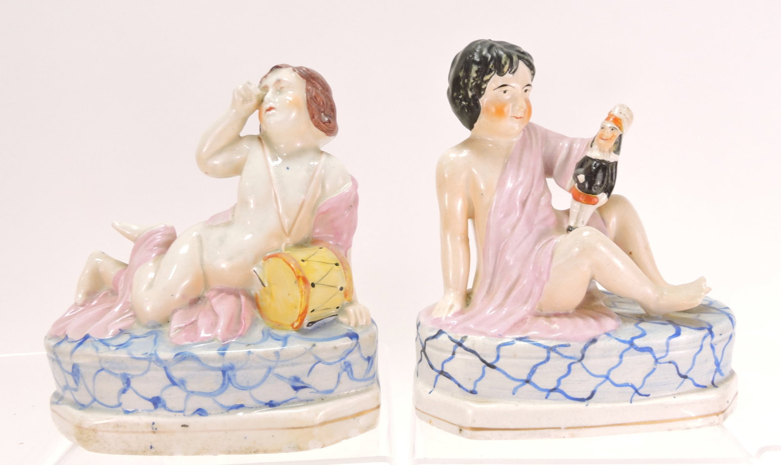 Staffordshire pair of children, one with: a drum, the other a doll, 7"