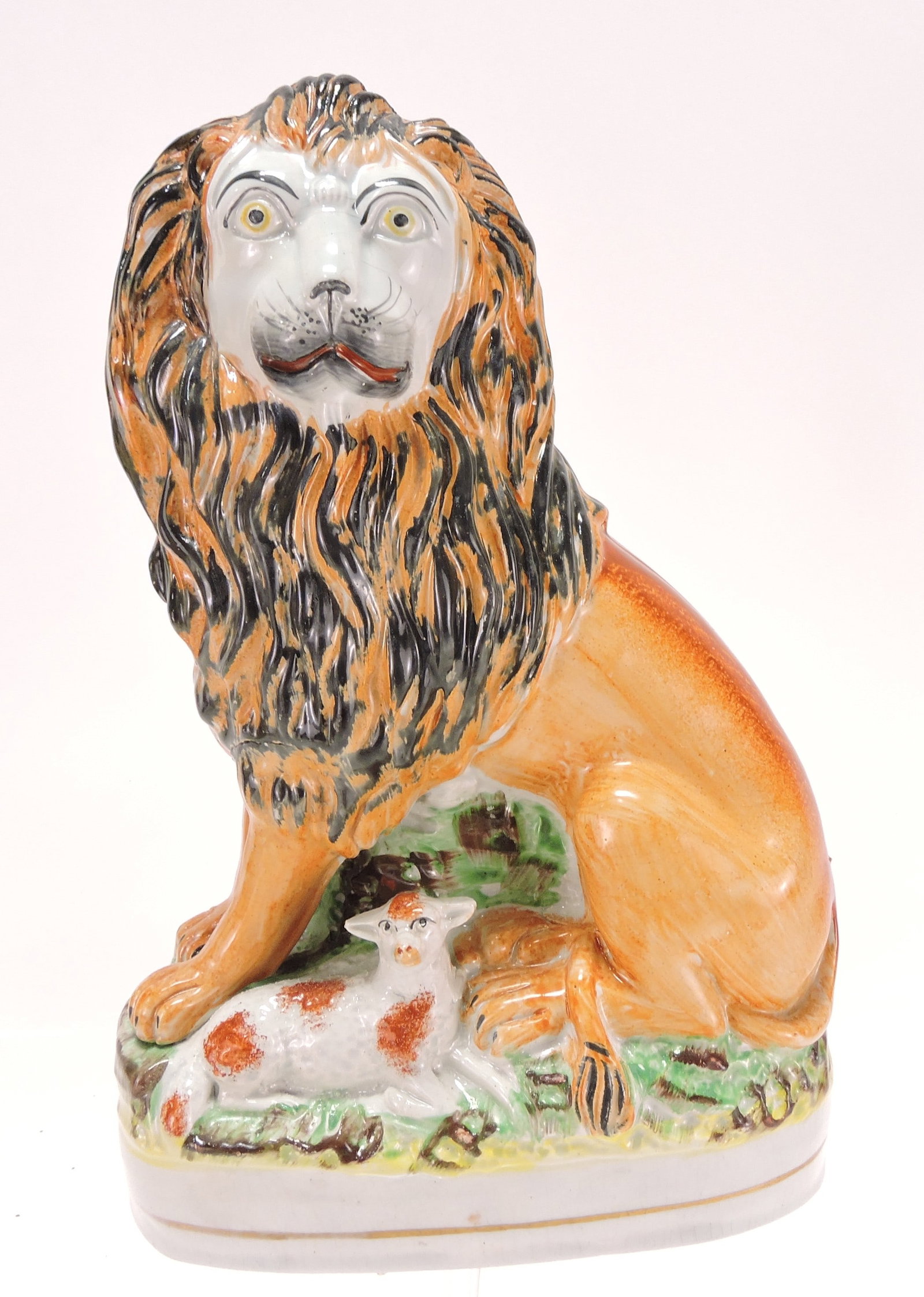 Staffordshire lion with lamb figure,: 10 1/2"