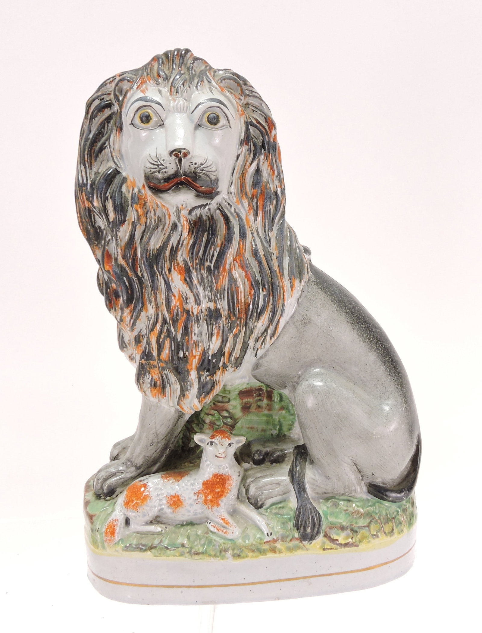 Staffordshire lion with lamb figure,: 10 1/2"