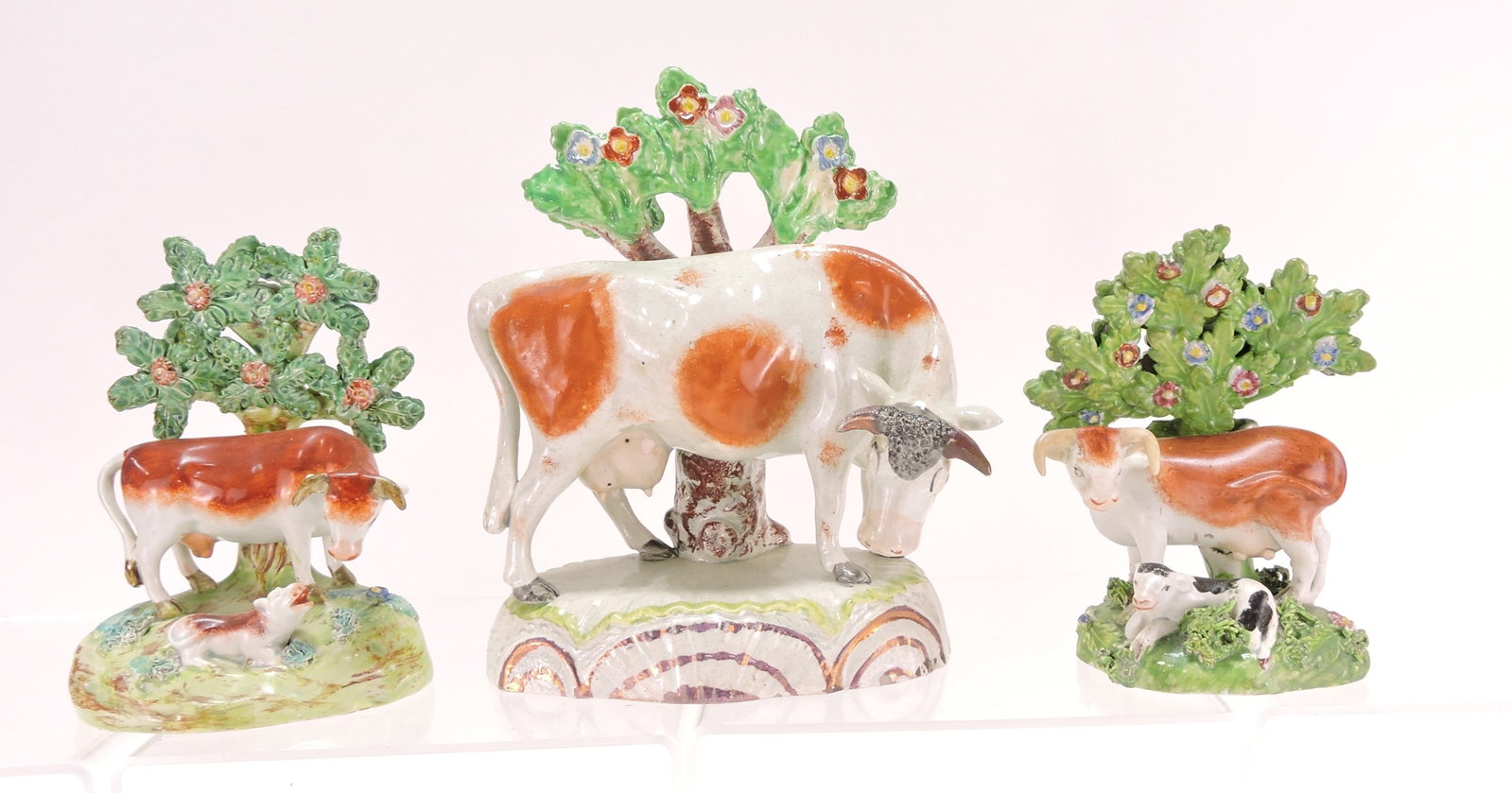 Staffordshire lot of 3 cow figures,: 5 1/2" to 7"