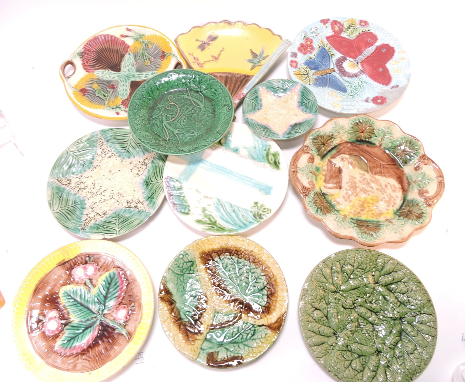 Majolica lot of 11 plates and trays,: various condition