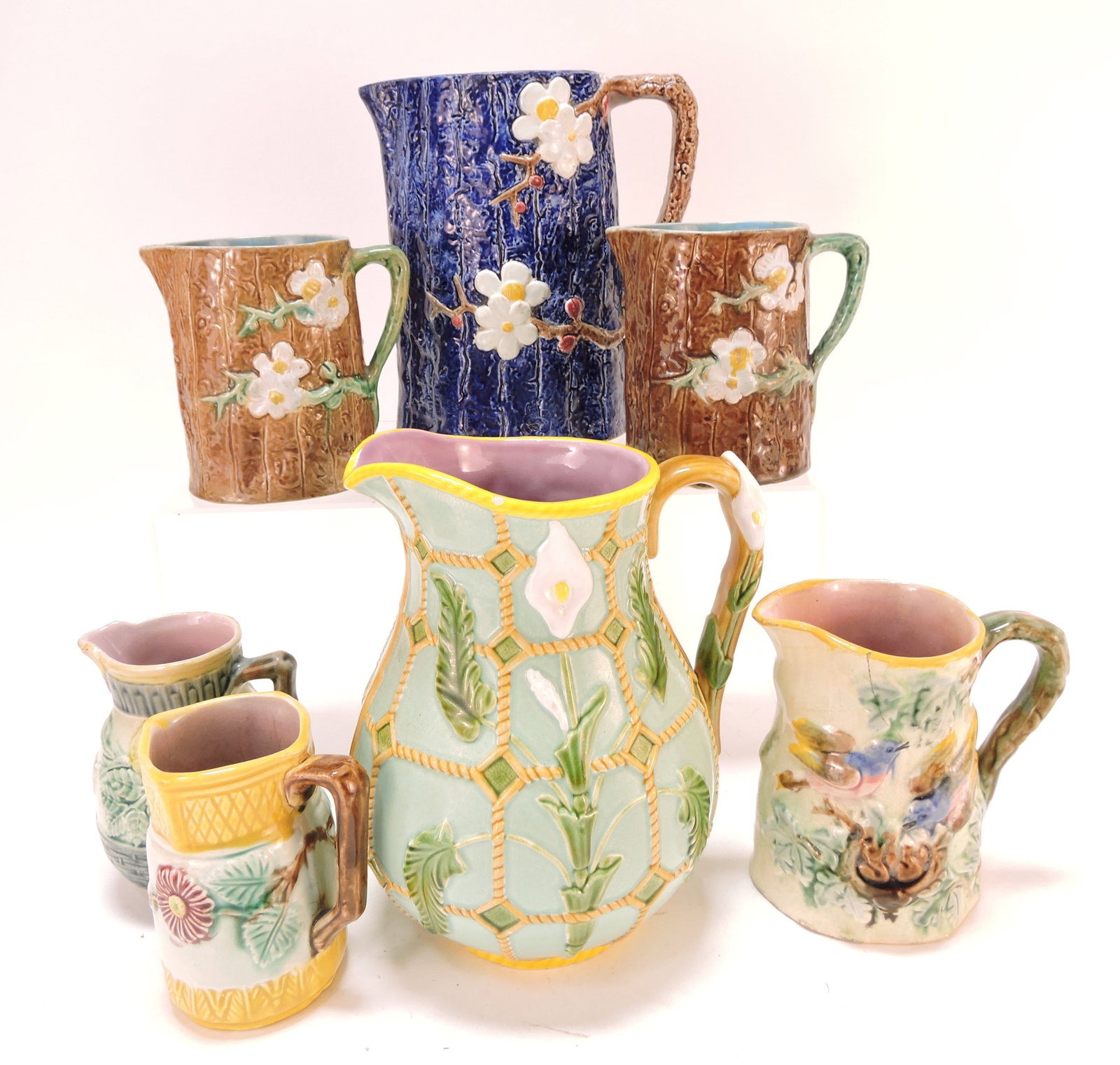 Majolica lot of 7 pitchers, 4" to 8",: various condition