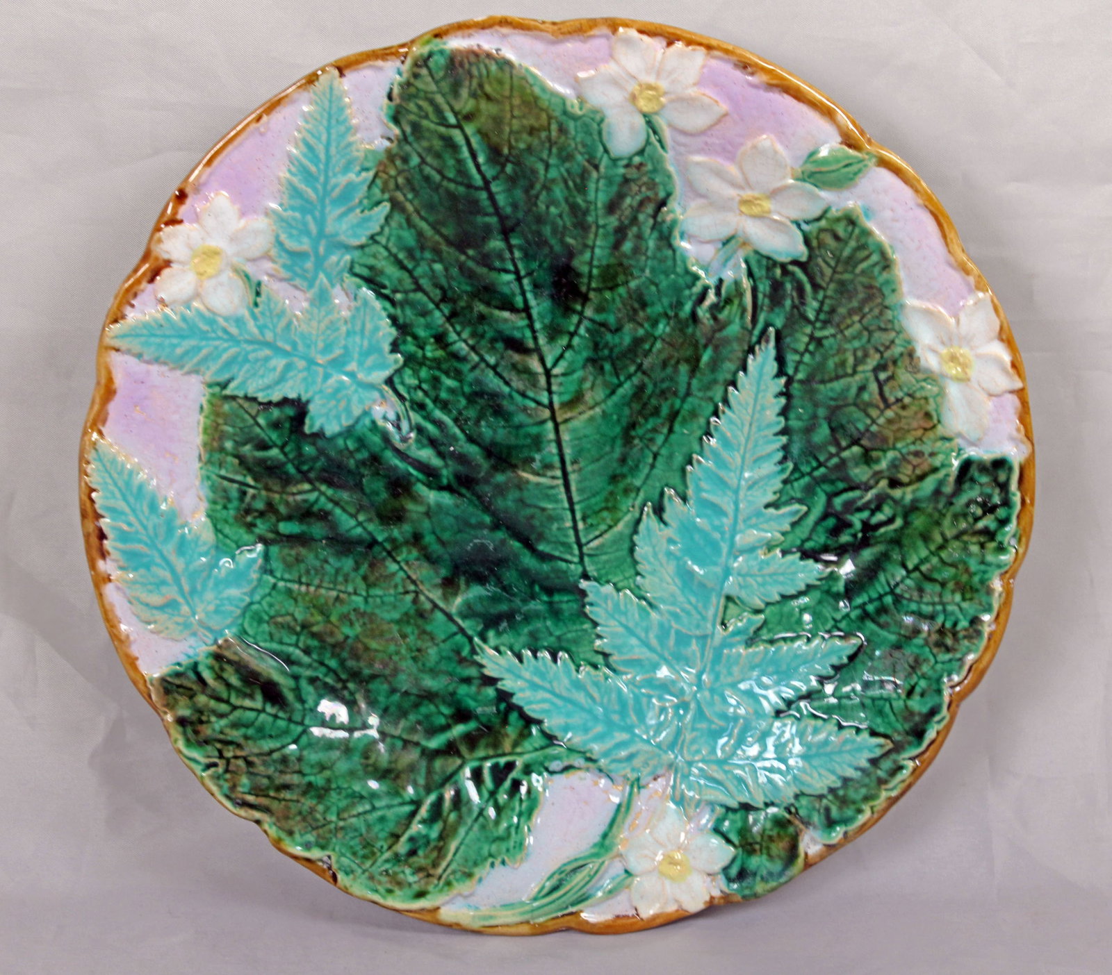 Majolica plate attributed to Joseph: Holdcroft on twig feet moulded with ferns, leaves, and flowers on a pink ground, excellent color & detail ,8 1/4"