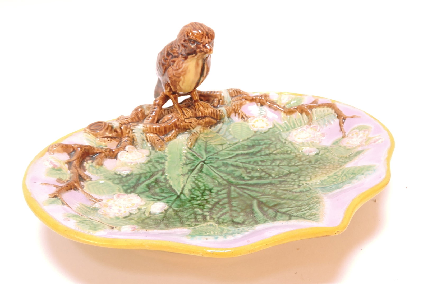 George Jones majolica server with bird: handle and pink ground, 5"h, 10 1/2"w, professional repair to bird's tail