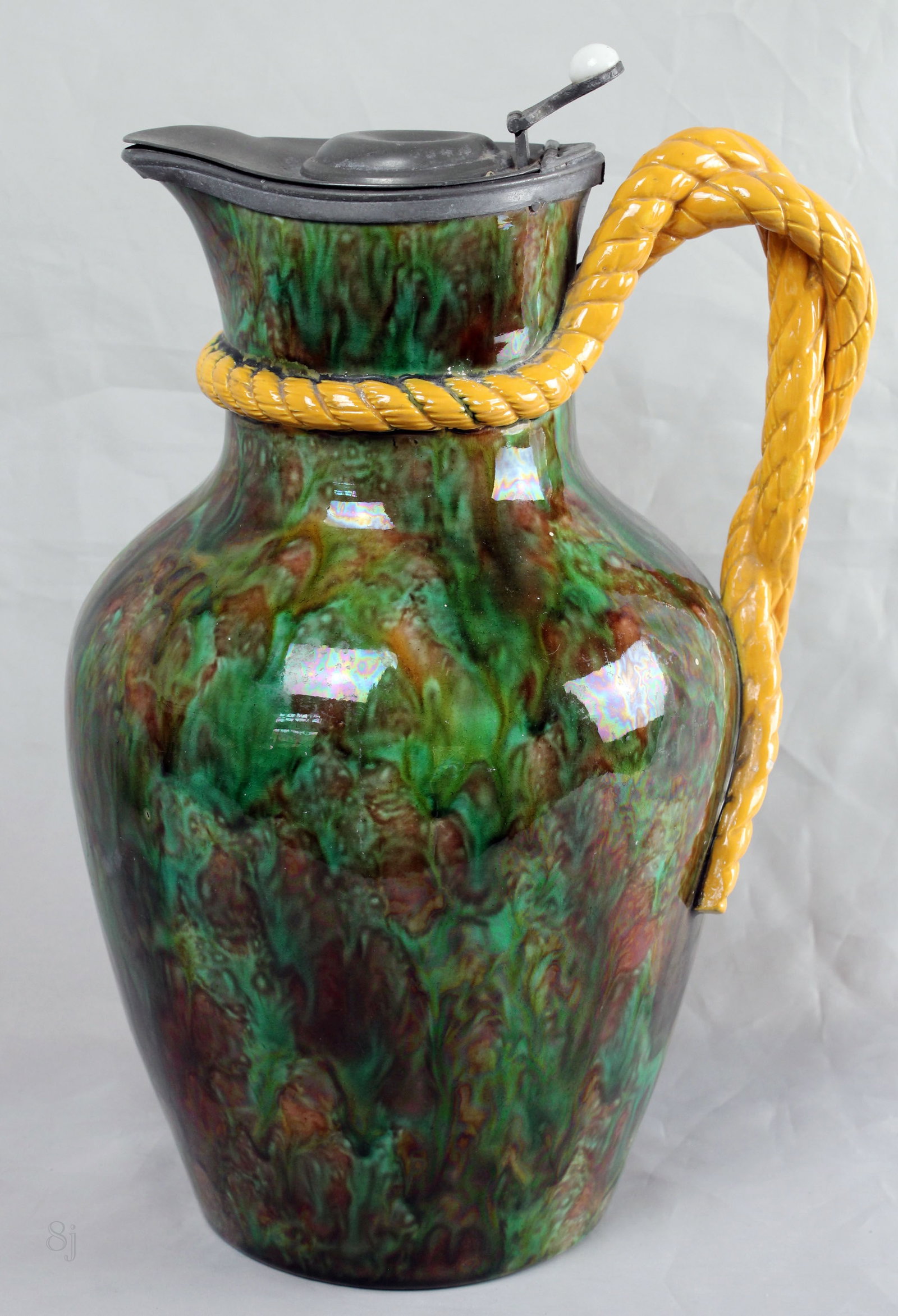 George Jones majolica tortoise shell: ground lidded ewer with a yellow rope twist handle, pewter lid ,10”h, shape no.2777 to the base