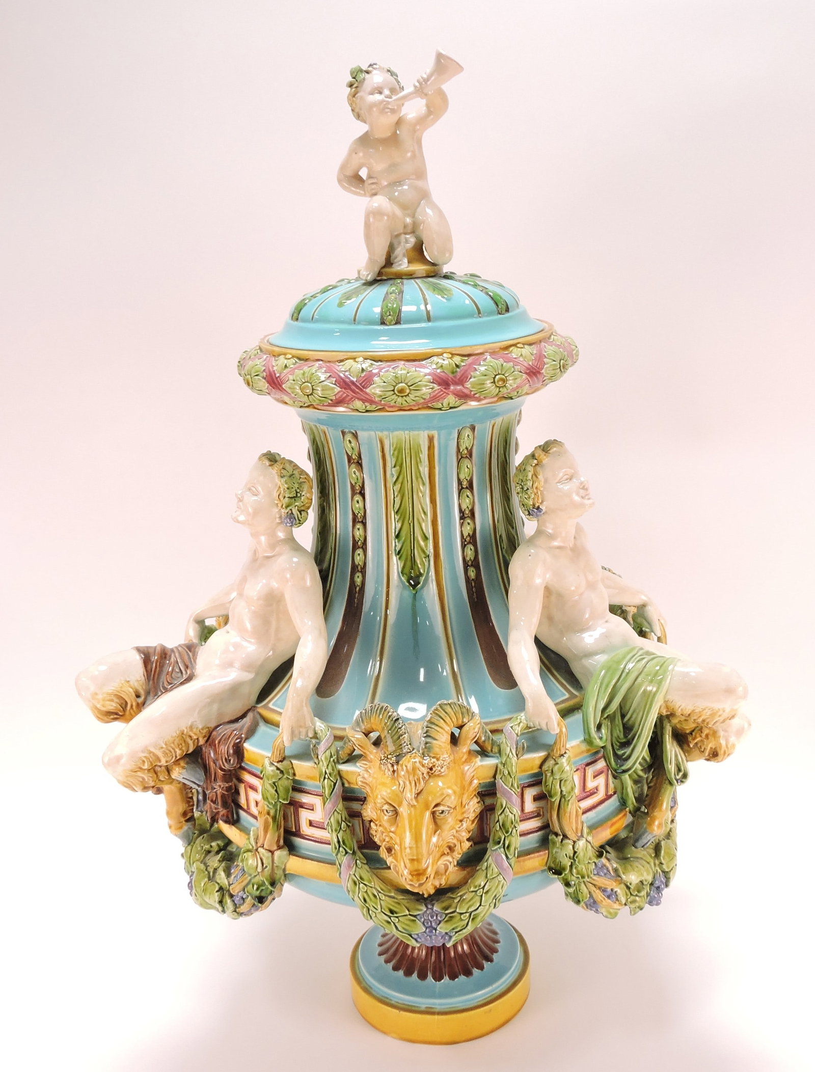 Minton majolica large covered urn: with three satyrs and ram masks and cherub finial, 27 1/2"h, 20"w, professional repair to lid