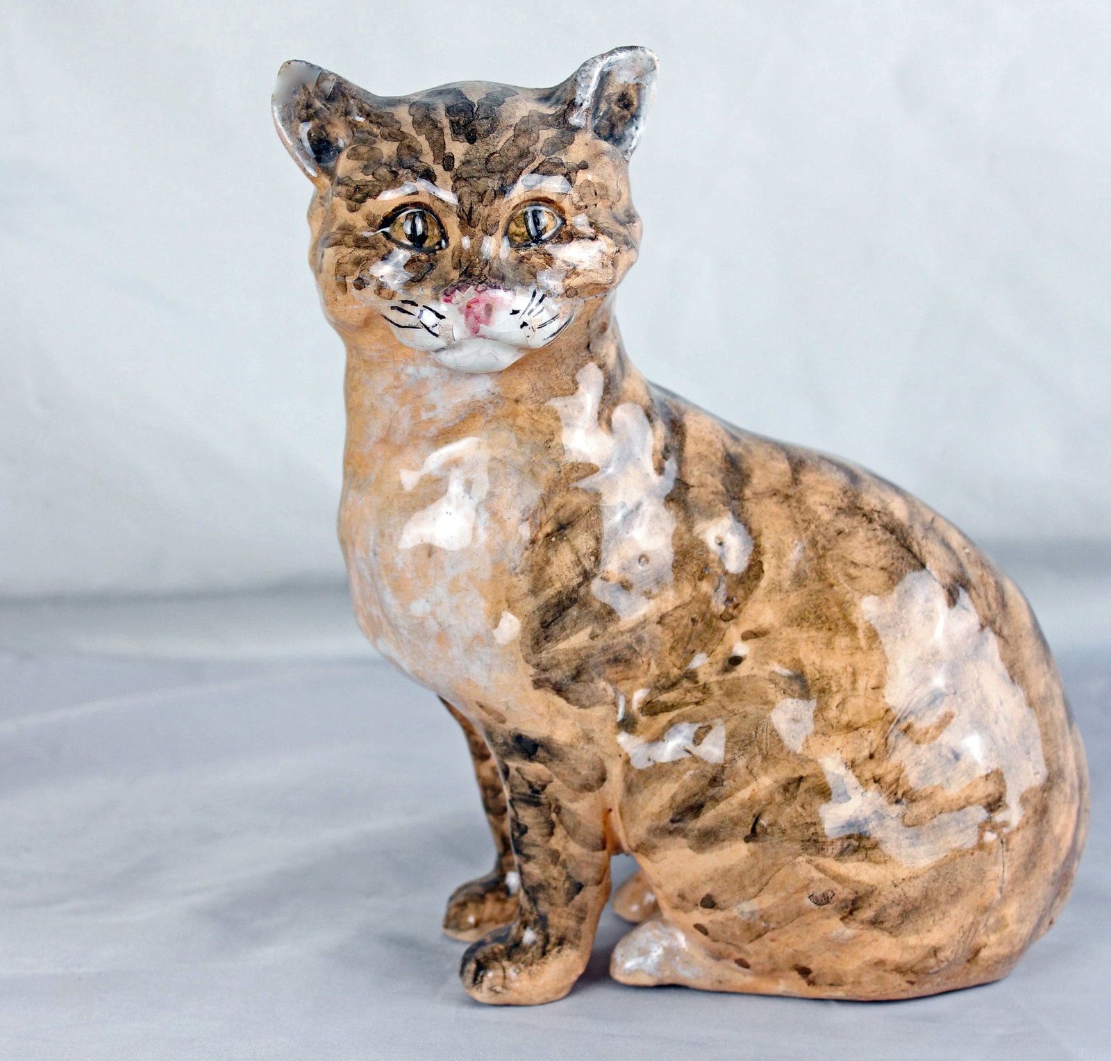 A Clement Massier majolica figure: of a cat, great color and detail, 7” h, impressed marks to base