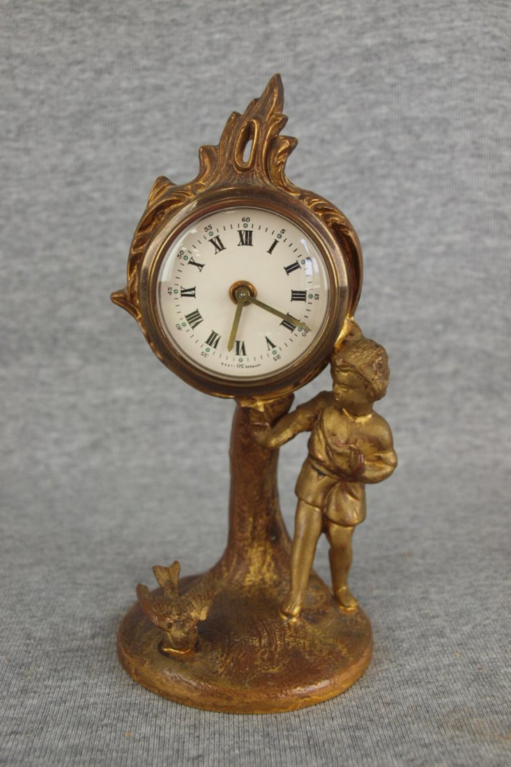 Iron novelty clock with boy and bird, clock works: Iron novelty clock with boy and bird, clock works replaced, 7 1/2"