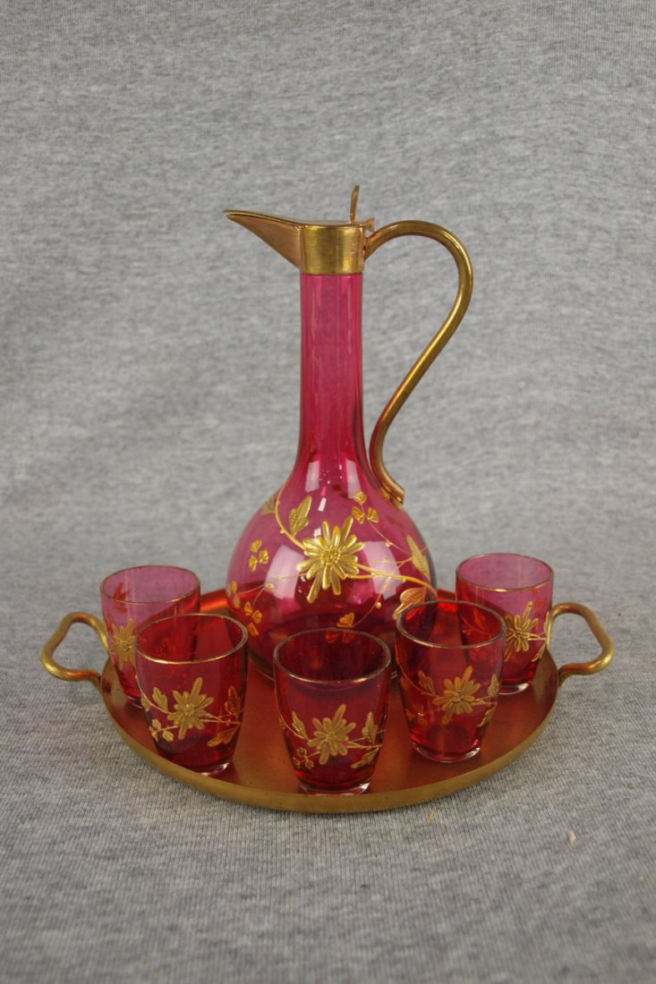 Moser cranberry gold overlay floral motif liquor set: Moser cranberry gold overlay floral motif liquor set with ewer and 5 glasses with brass tray, 7 1/4"h